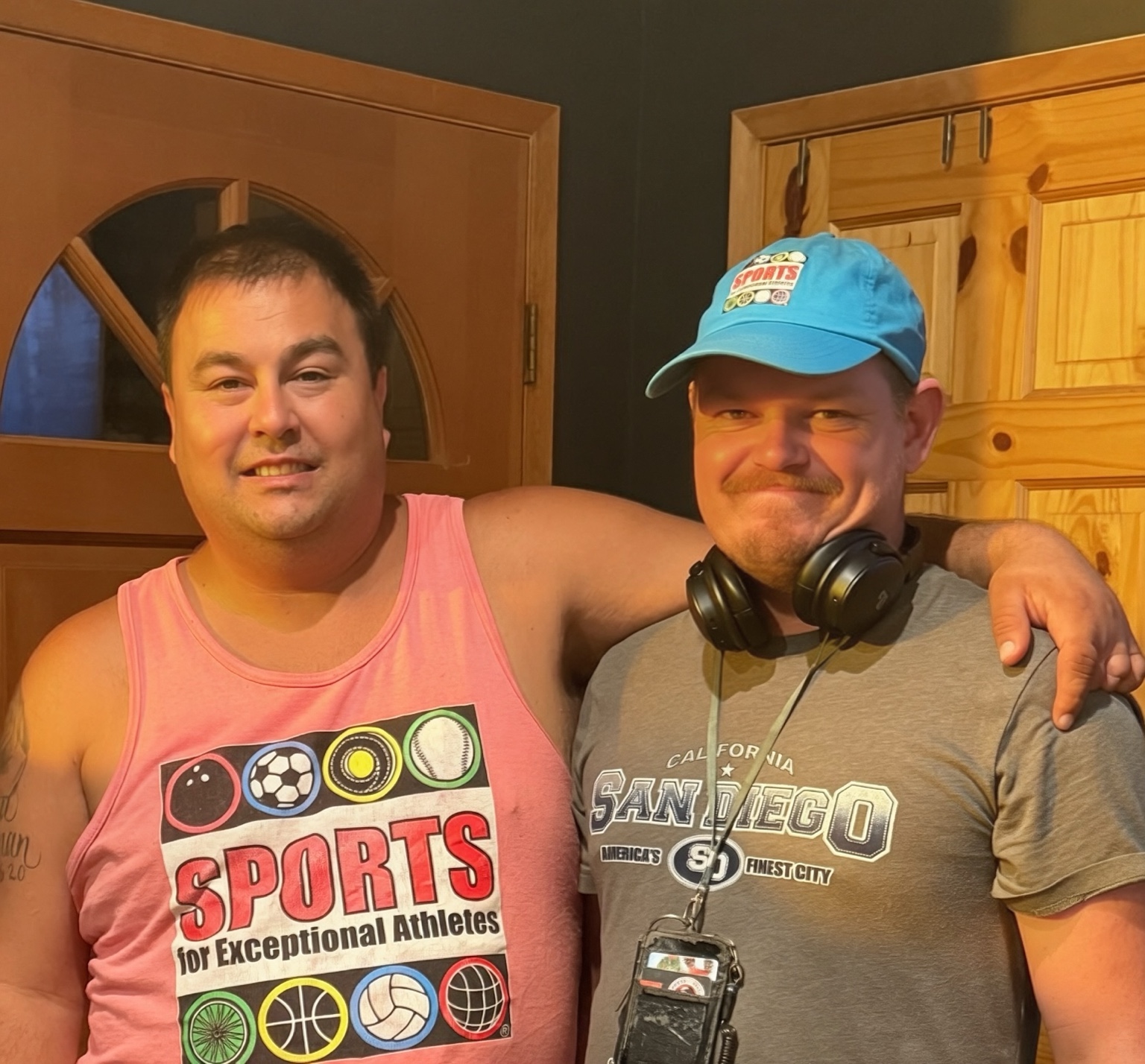 Lane smiling with his friend and coach Donald C. after celebrating his softball achievement